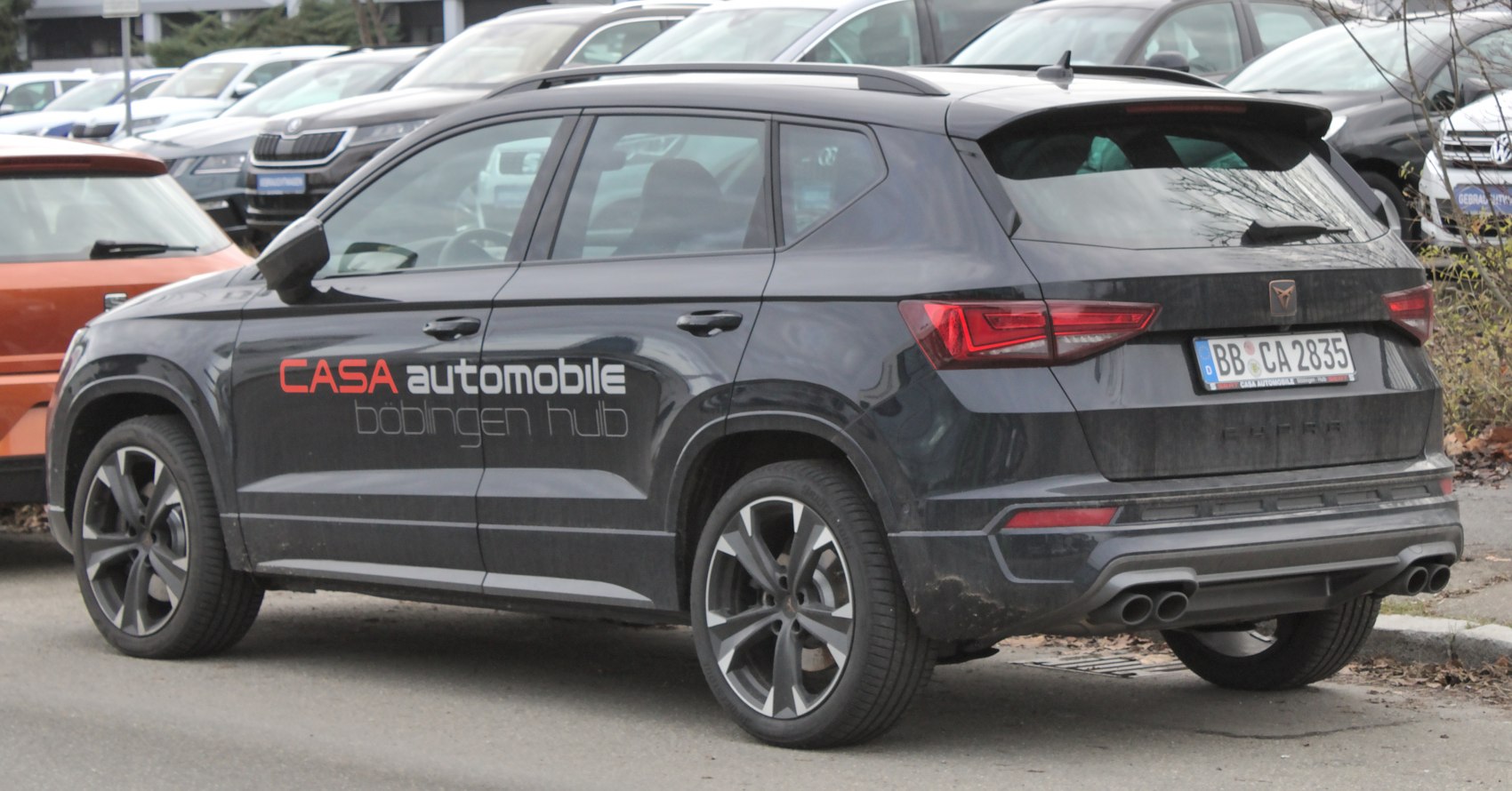 Rear and side view with dual exhausts and alloy wheels