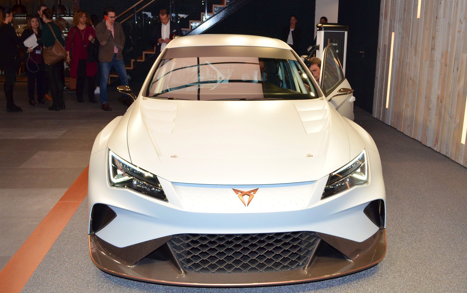 White sports car front with sharp LED headlights and aerodynamic design