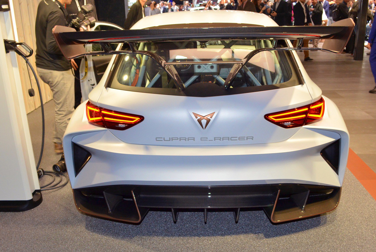 Rear view of electric racing vehicle with large spoiler and distinctive LED taillights