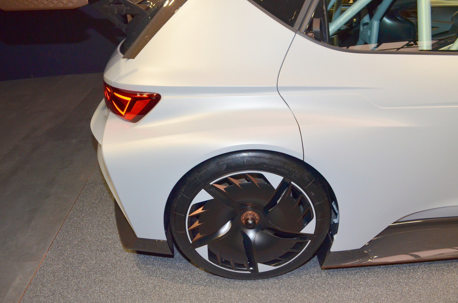 Close-up of rear wheel and tail light with aerodynamic rim.