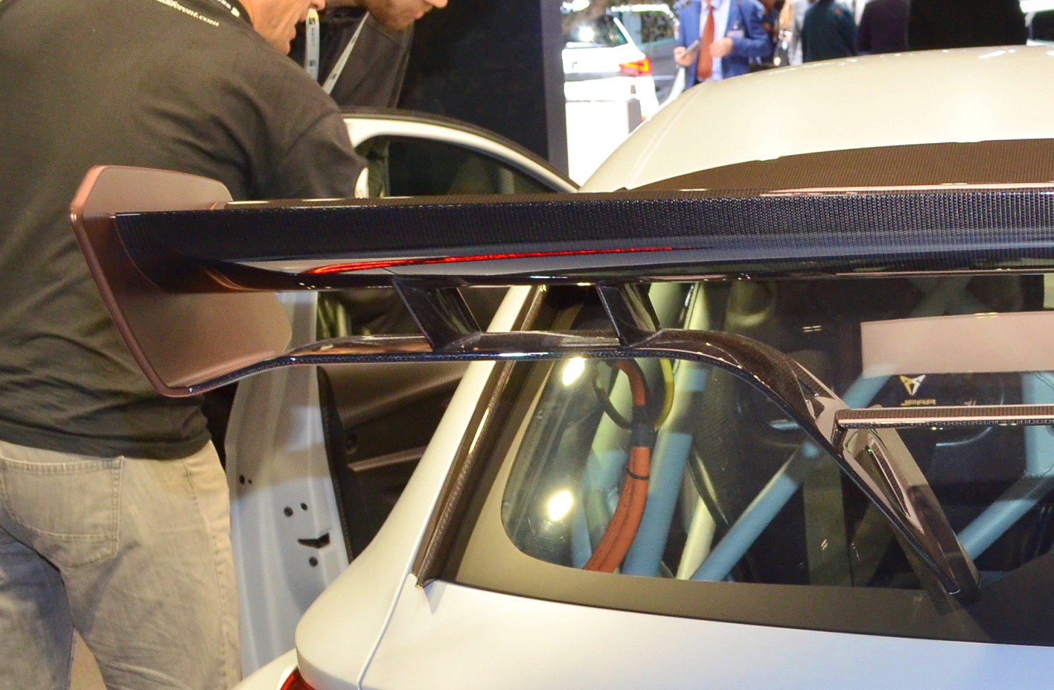 Carbon fiber rear wing with aerodynamic support on a race car