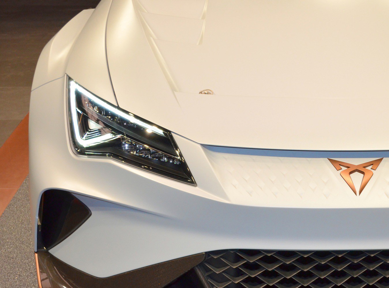 Sleek LED headlight and aerodynamic front design with copper emblem