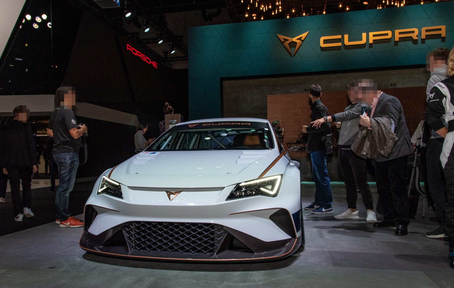 Front view with triangular LED headlights and large mesh grille