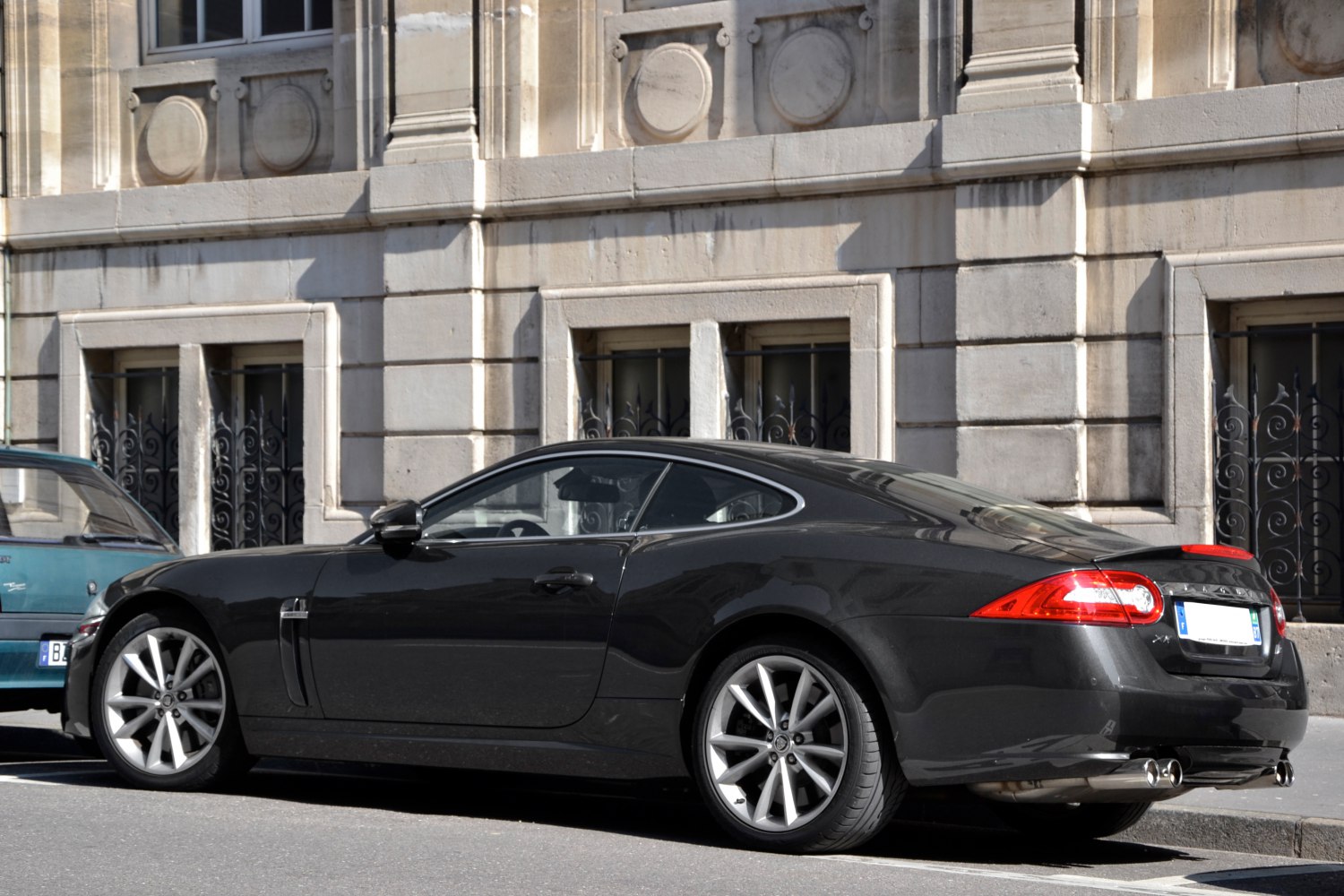 Sporty coupe rear-side profile with alloy wheels