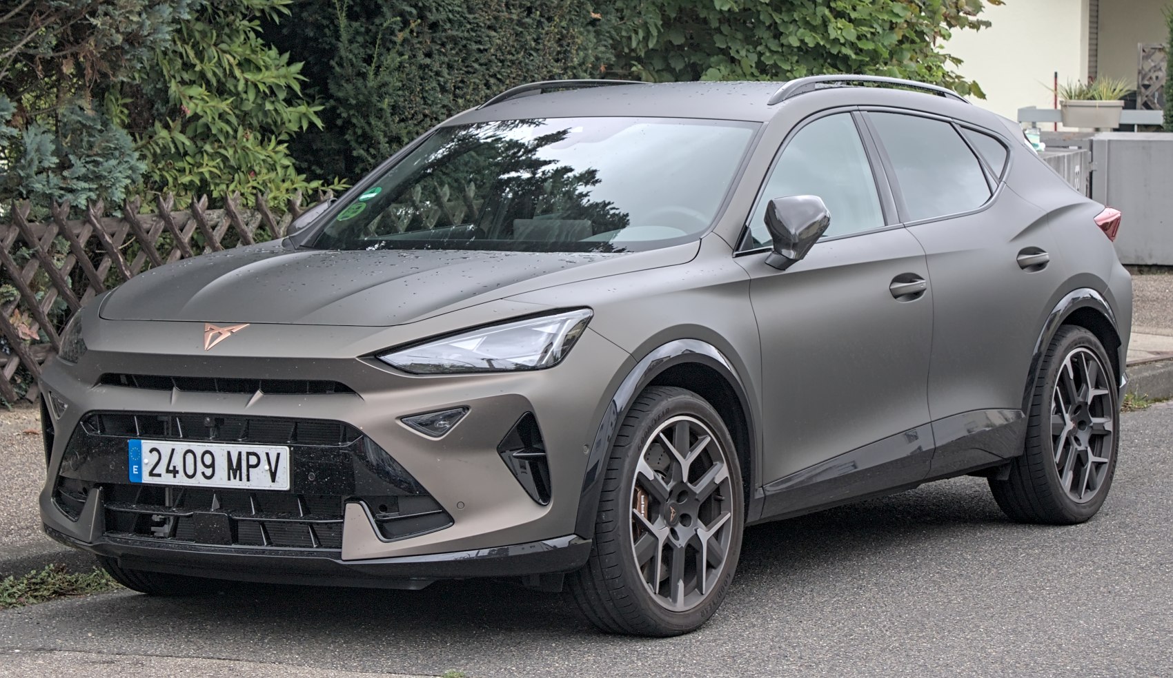 Matte finish SUV with sleek headlights and sporty alloy wheels