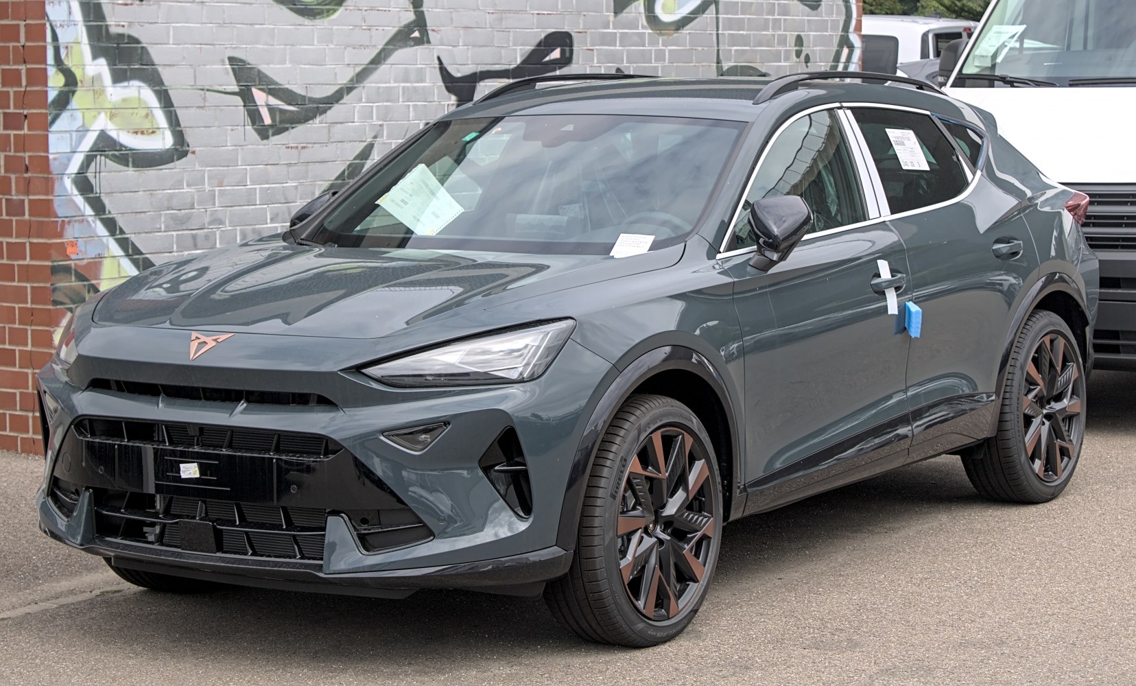Sleek angular LED headlights, bold grille, sporty alloy wheels, and roof rails on modern SUV.