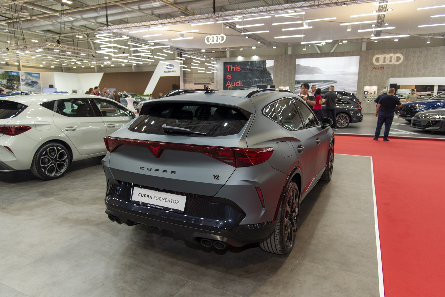 Rear view of modern crossover SUV with sporty taillights and dual exhausts
