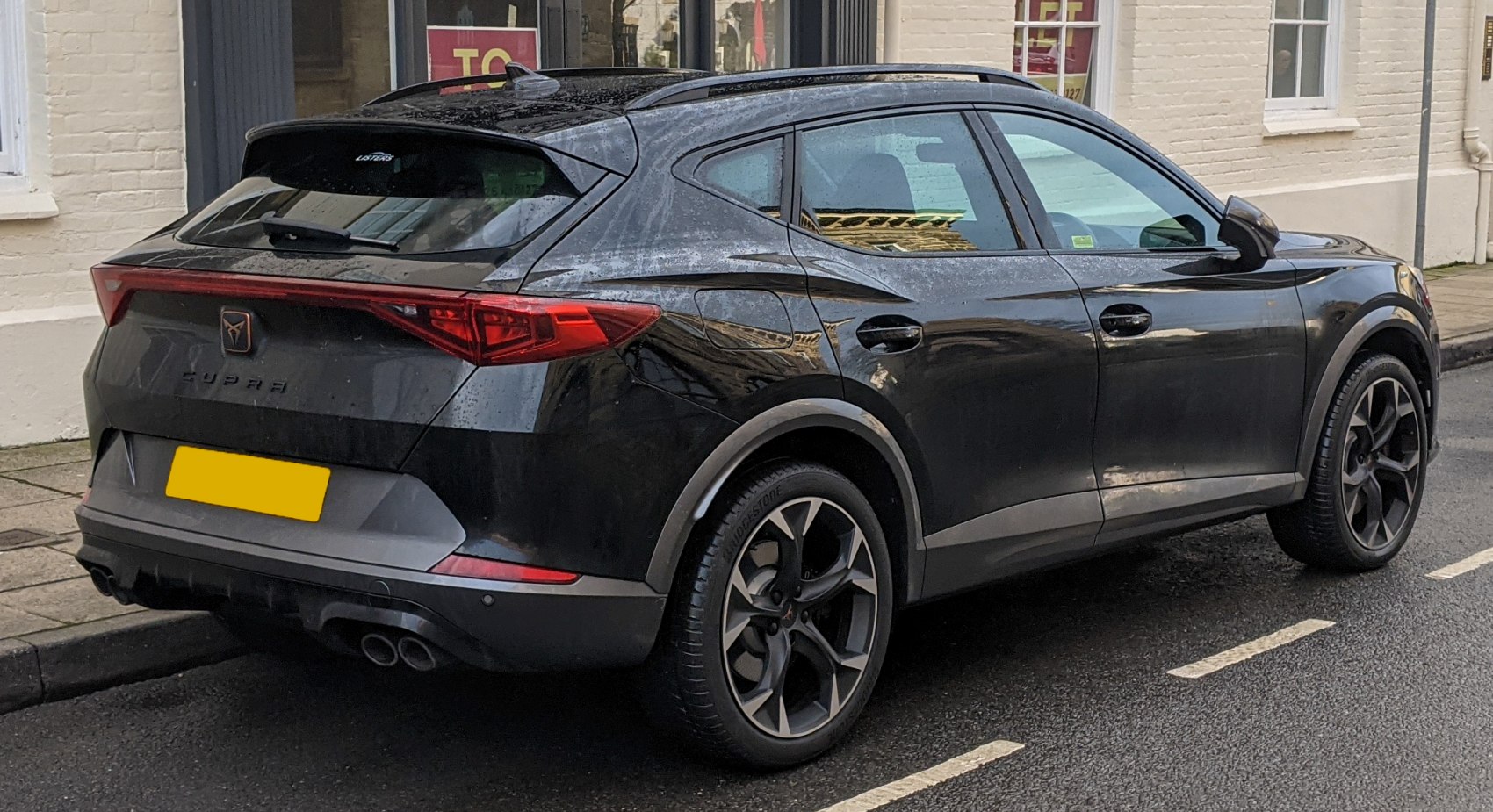Rear side profile of modern SUV with dual exhausts and distinctive rear lights