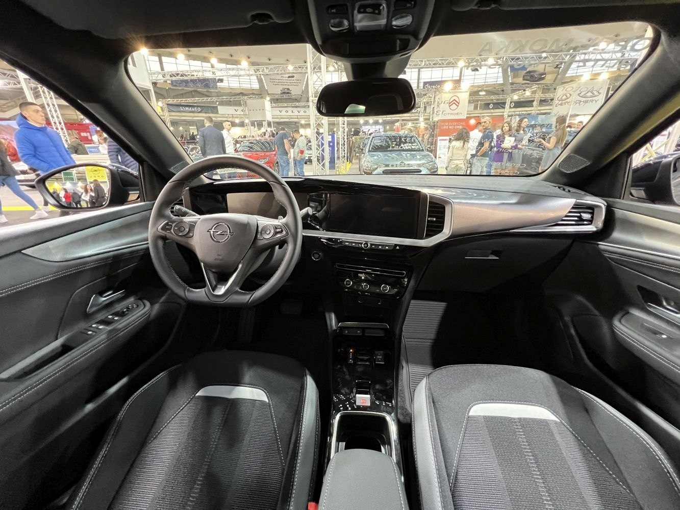 Digital dashboard and ergonomic steering wheel in car interior.