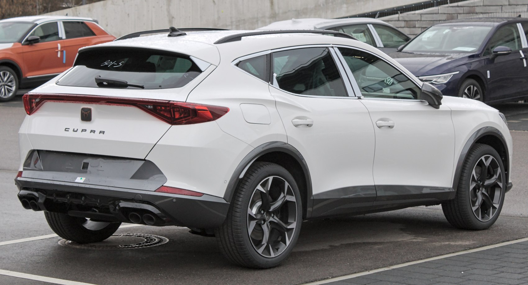 Rear view of vehicle with LED tail lights, quad exhaust, and sporty wheels