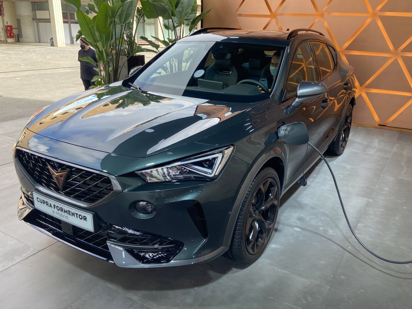 Front view of a hybrid SUV with LED headlights and charging port.