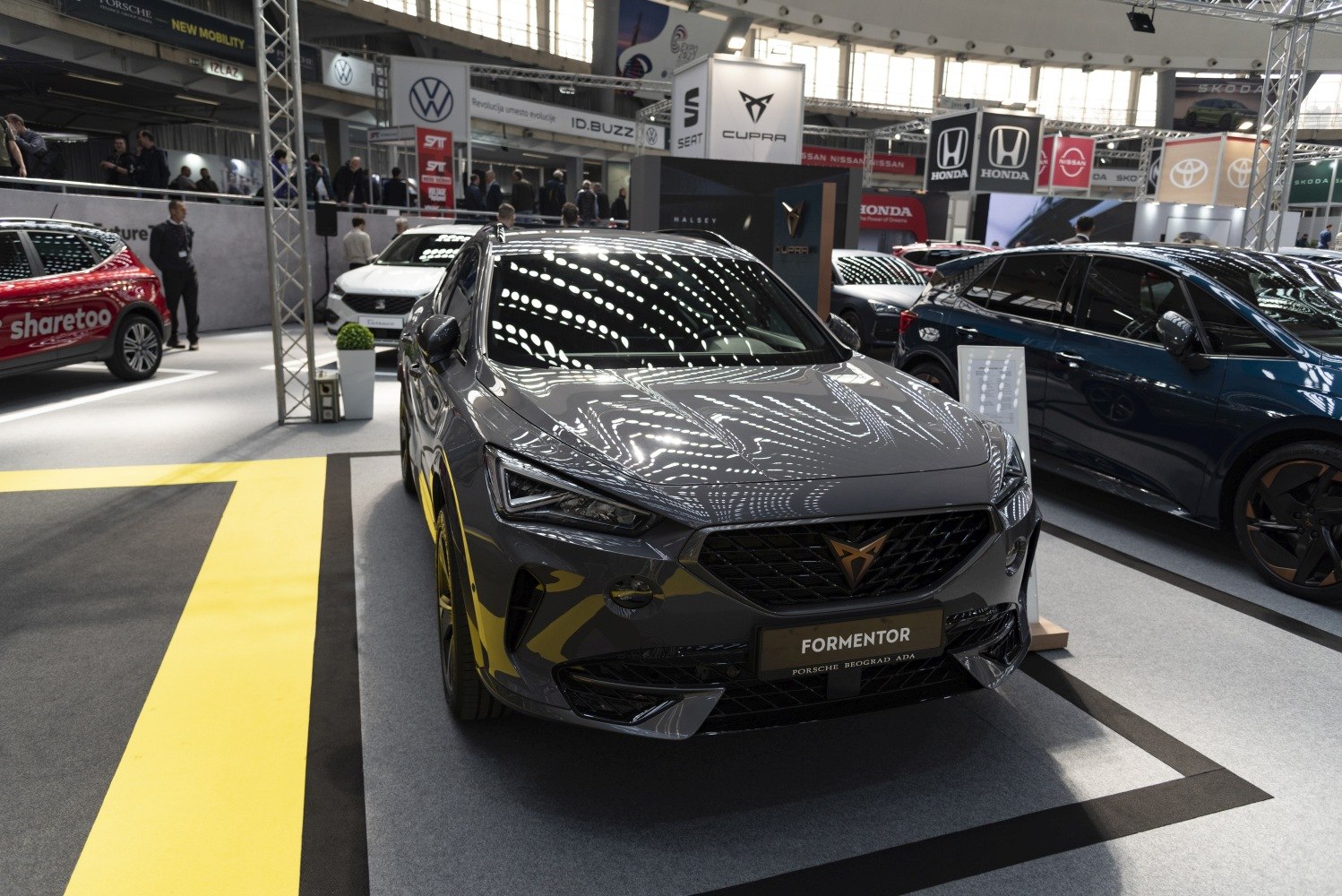 Front view of a sporty SUV with sharp LED headlights and honeycomb grille.