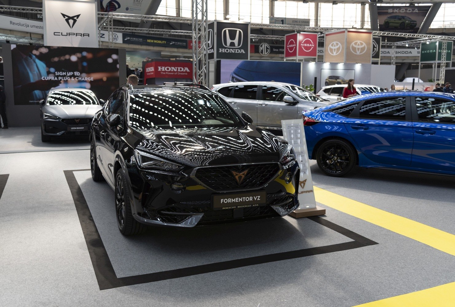 Black sleek sporty SUV front view with sharp headlights and mesh grille.