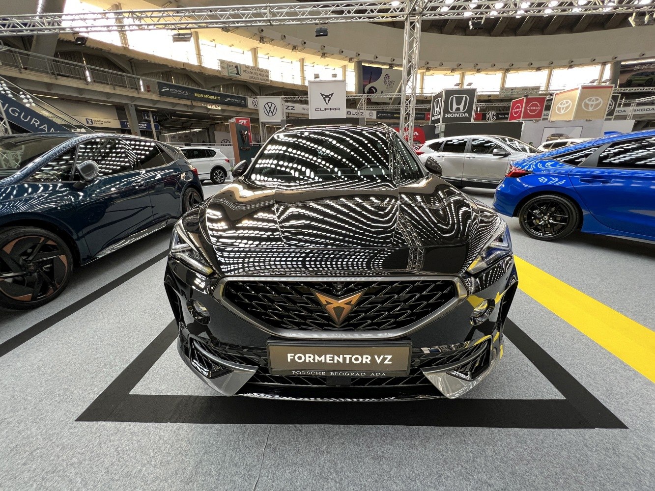 Close-up of car front showing grille, badge, headlights