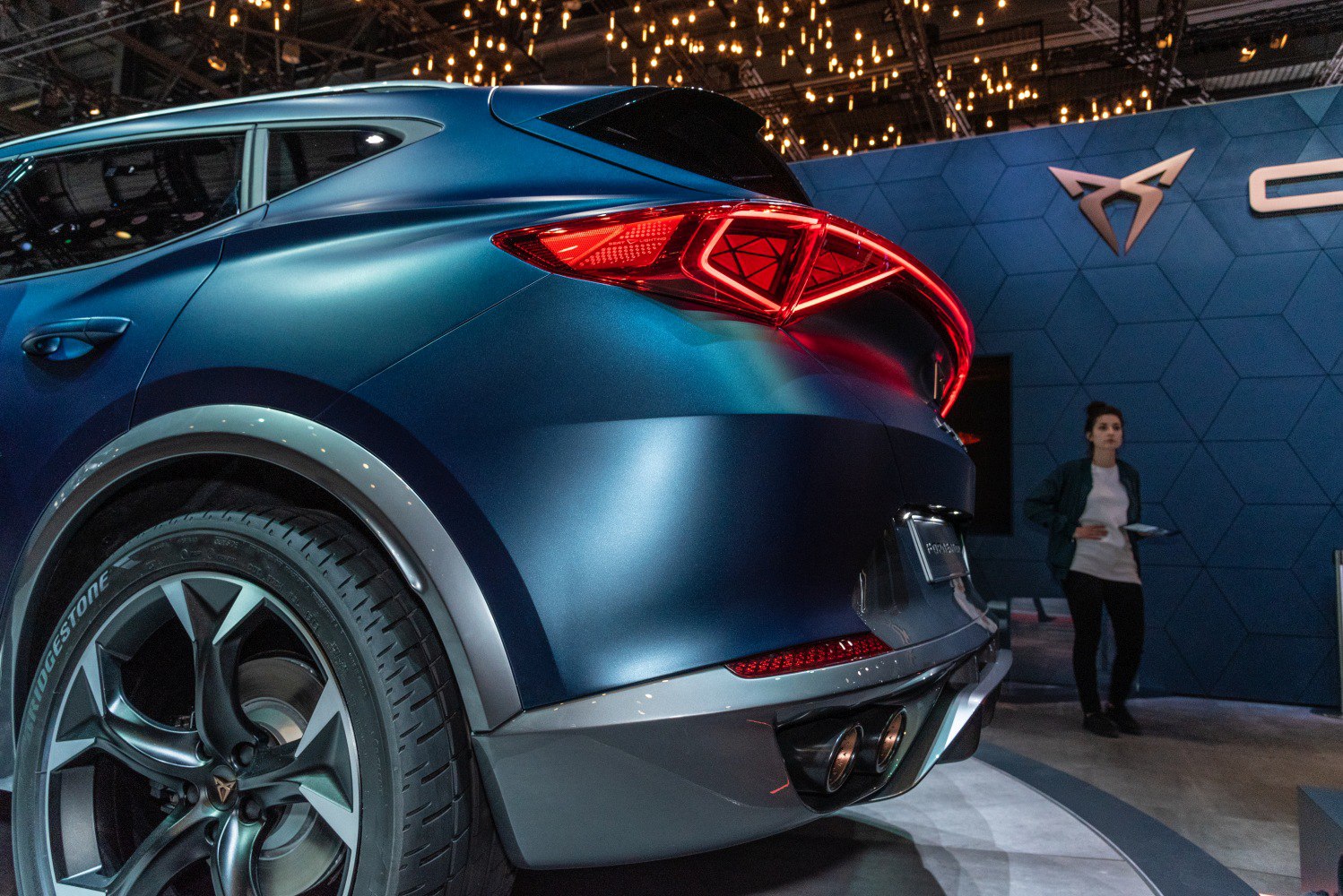 Rear end and illuminated taillight of a sporty SUV concept car