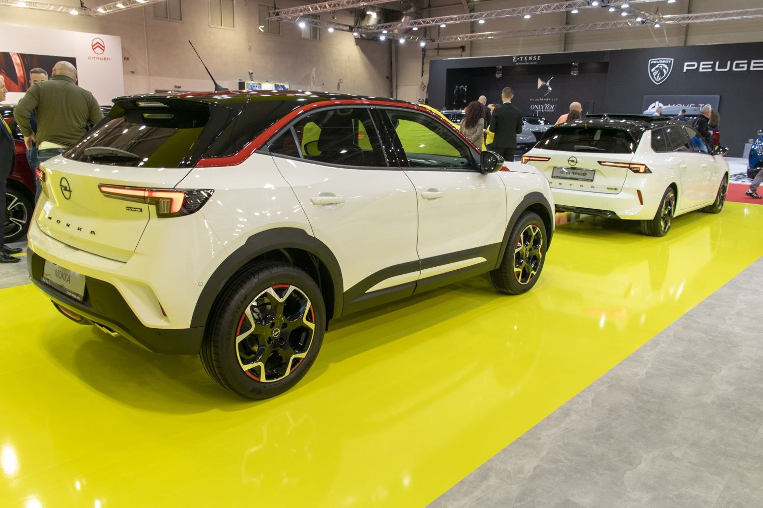 White SUV with black roof, red accents, and modern rear design