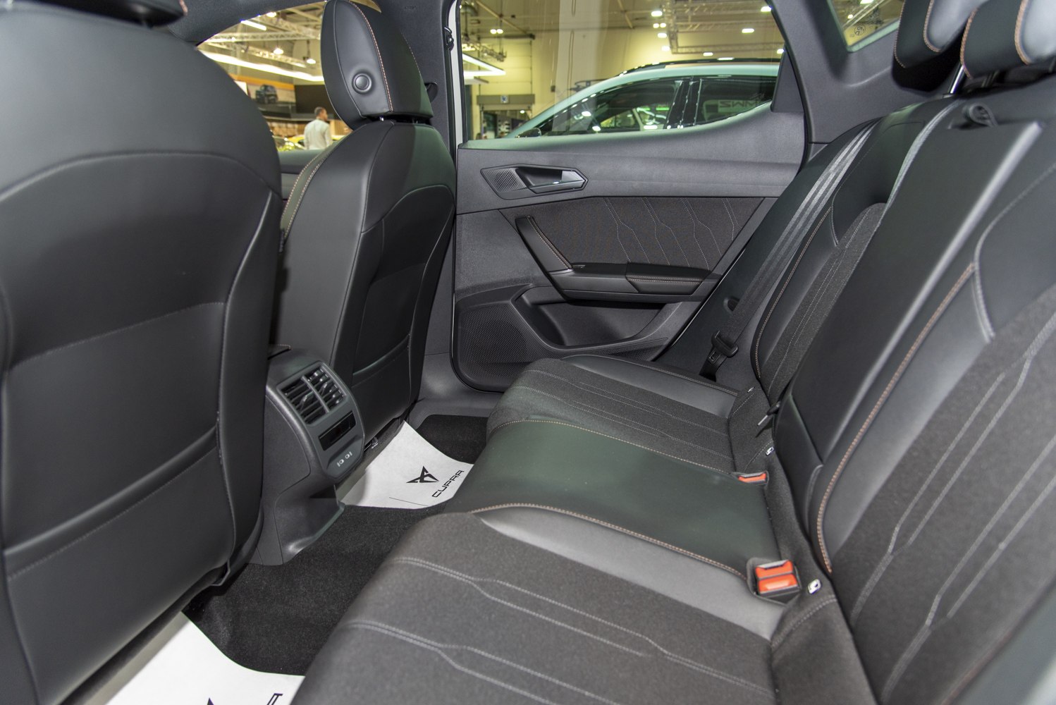 Rear seat interior with leather and fabric upholstery and rear air vents