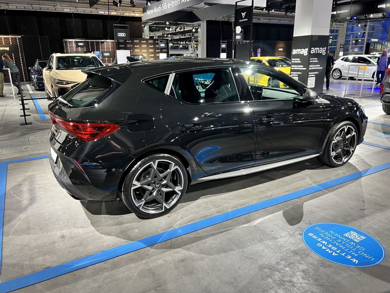 Sporty hatchback side view with distinctive alloy wheels and sleek rear design