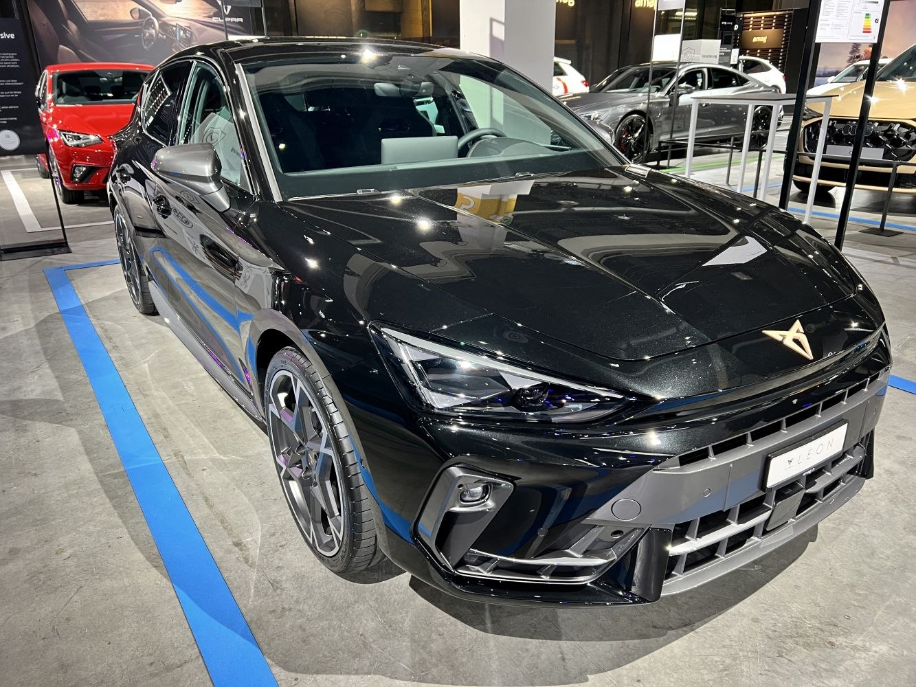 Sharp front headlights and aggressive bumper of a black hatchback
