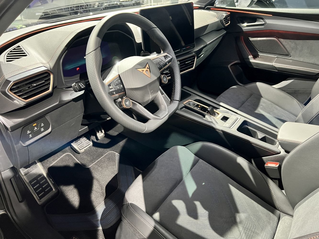 Sporty steering wheel and digital dashboard in modern car interior