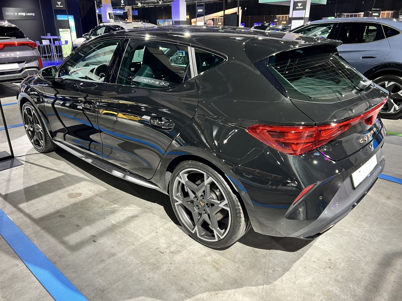 Black hatchback with distinctive rear LED lights and multi-spoke alloy wheels.