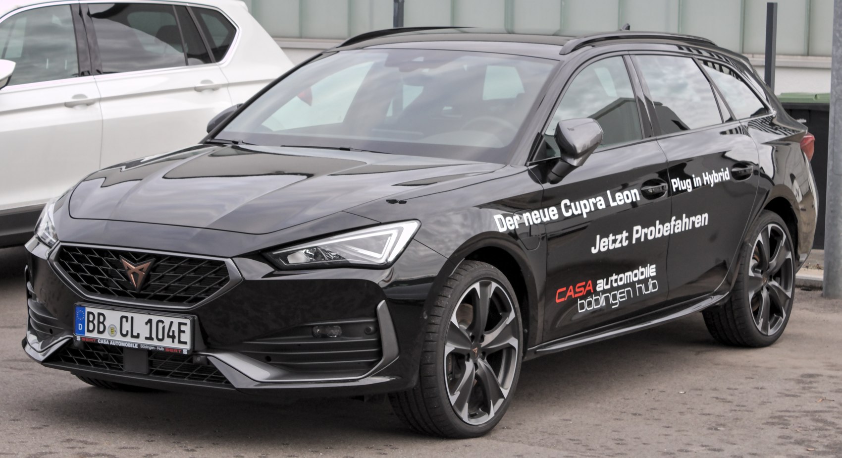 Black plug-in hybrid sporty wagon with distinctive alloy wheels and sharp headlamps.