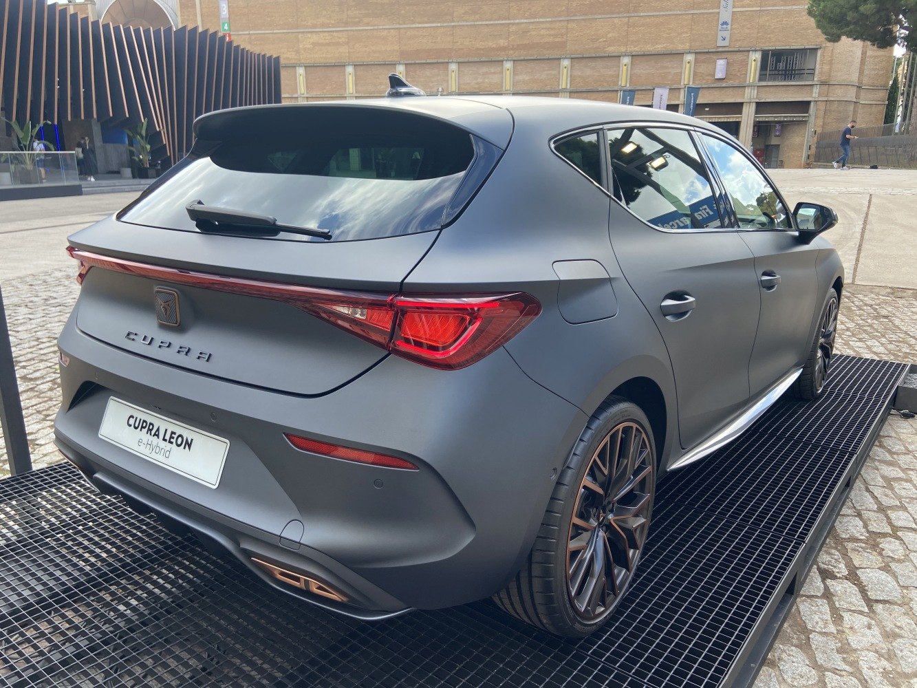 Rear view of hatchback with connected LED taillights and dual exhausts