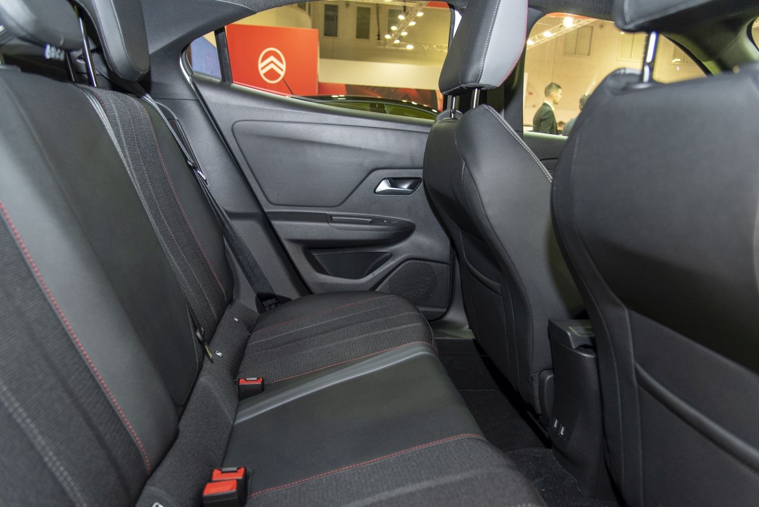 Rear seat interior with black upholstery and red stitching