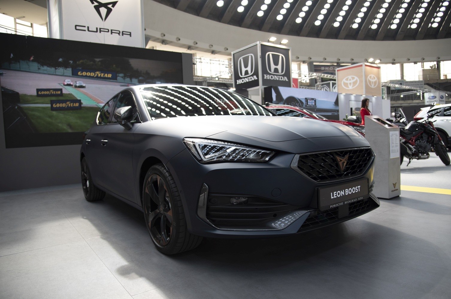 Matte black front view with sleek headlights and sporty alloy wheels