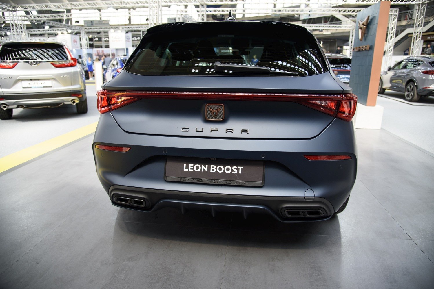 Rear view with LEON BOOST badge, full-width tail light, dual exhaust outlets