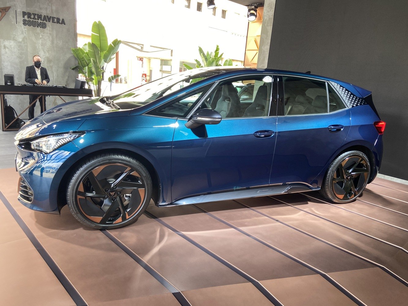 Side view of electric hatchback with LED headlights and black alloy wheels