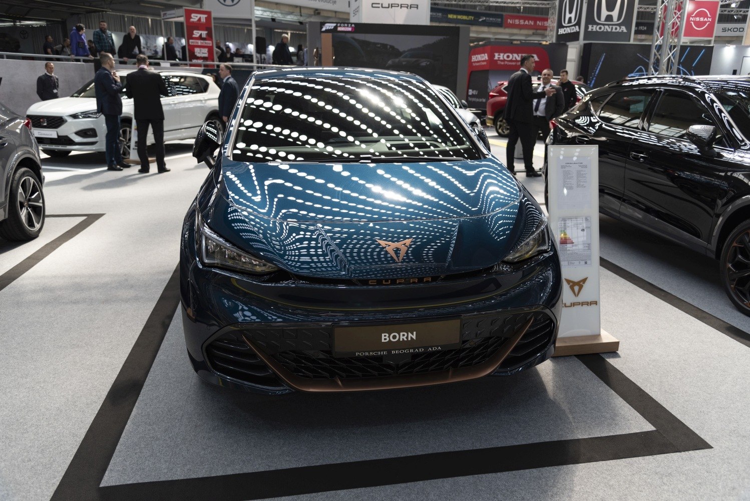 Front view of electric hatchback with sleek headlights and accented grille