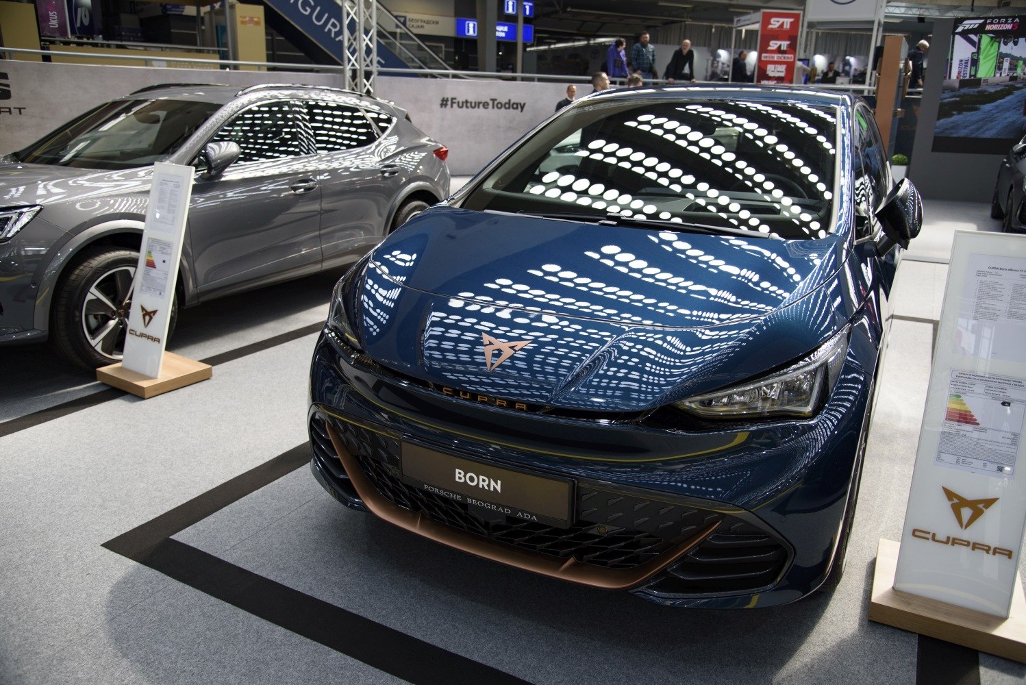 Front view of sleek hatchback with distinctive headlights and emblem