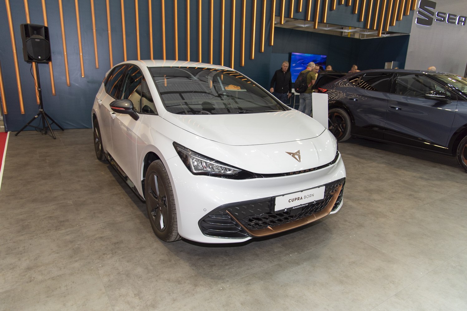 Front view of a sleek electric hatchback with LED headlights and aerodynamic bumper
