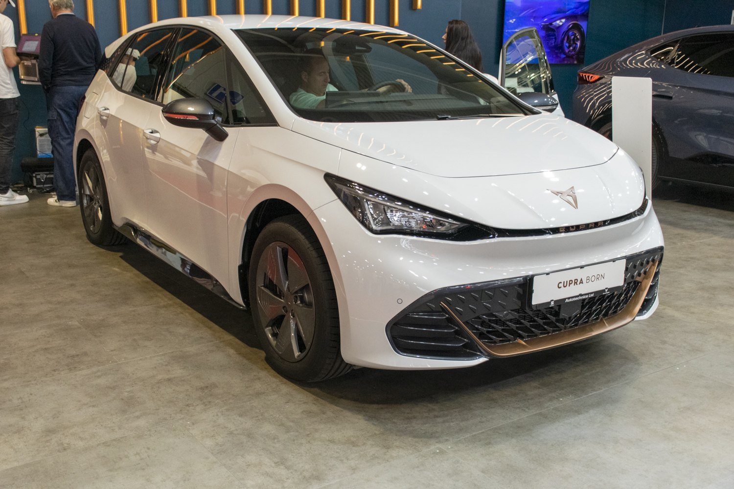 Electric hatchback front with LED headlights and aerodynamic styling.