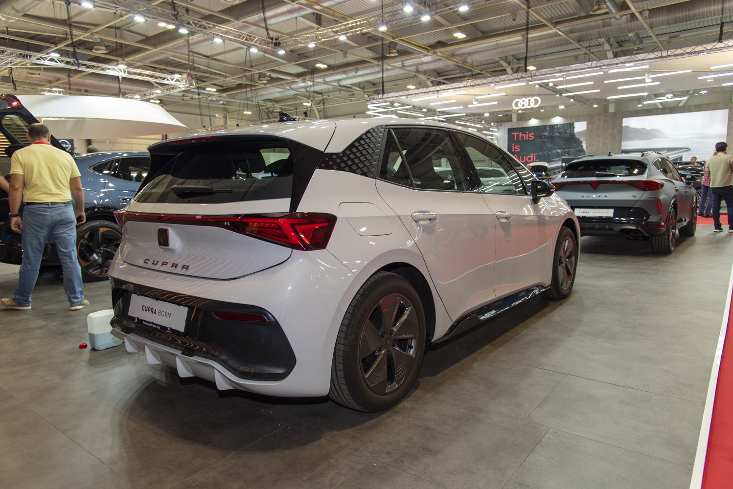 White electric hatchback with distinctive rear lights and unique wheel rims.