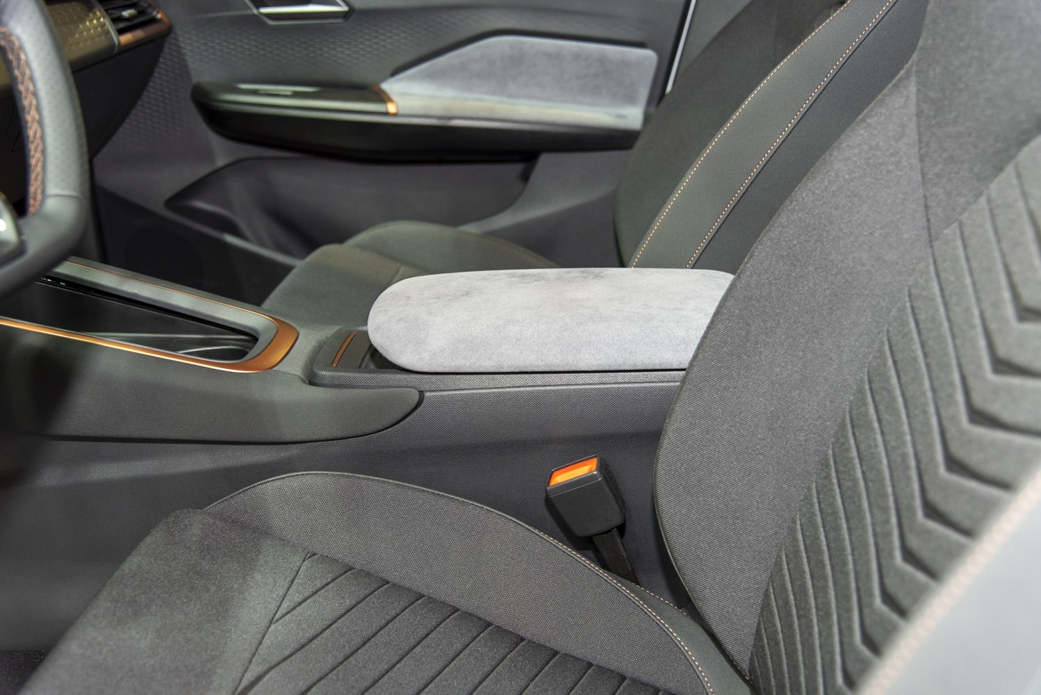 Car interior showing armrest and front seat upholstery details
