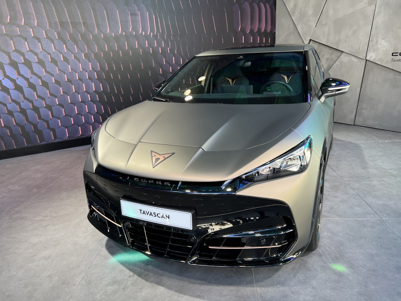 Front view of a sleek electric SUV with LED headlights and an aerodynamic bonnet