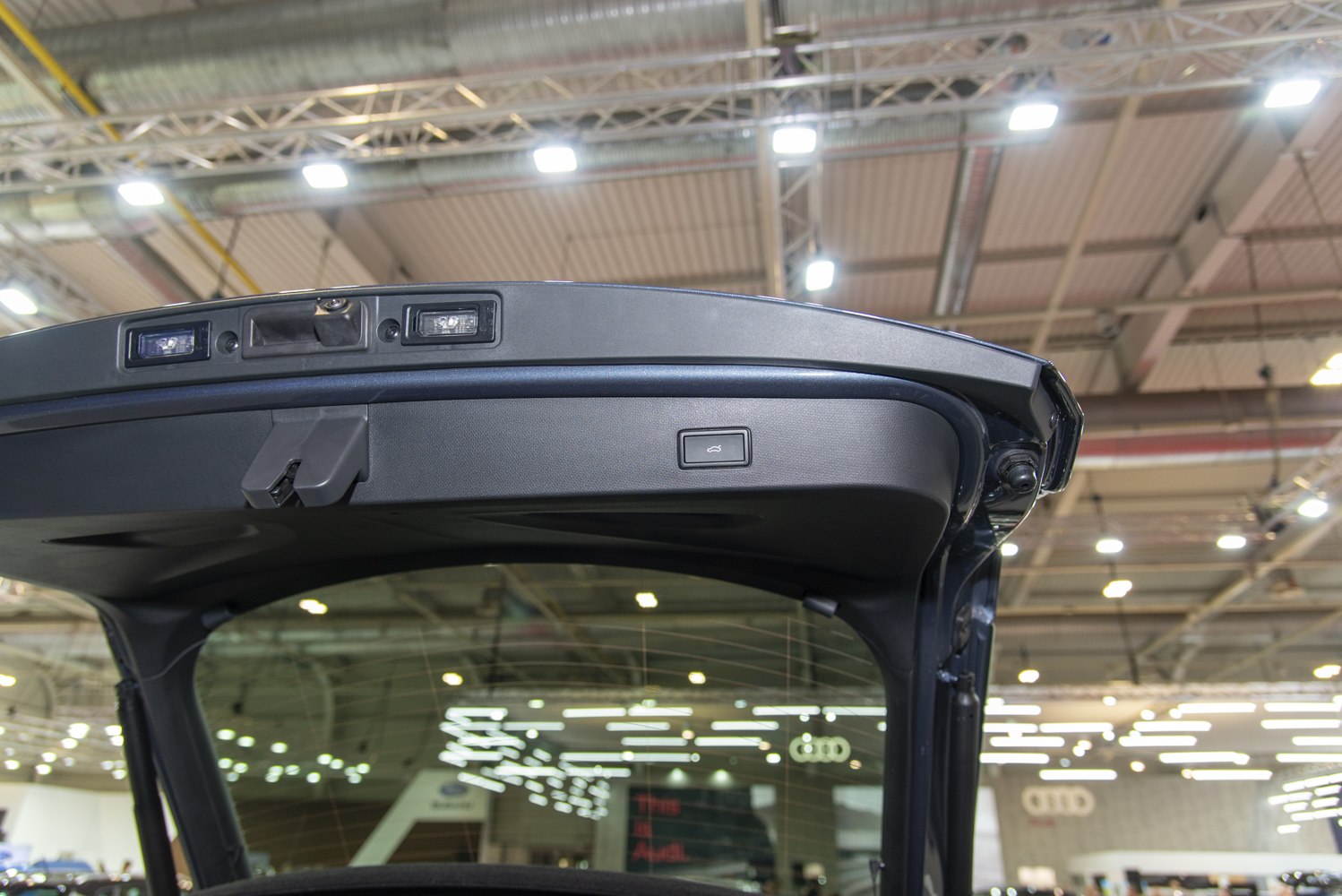 Rear hatch interior with lighting and electric trunk release button