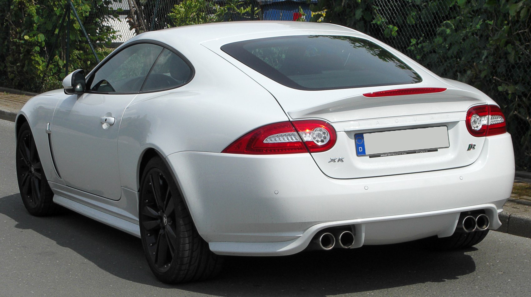 Rear view of sleek coupe with quad exhaust and distinctive taillights