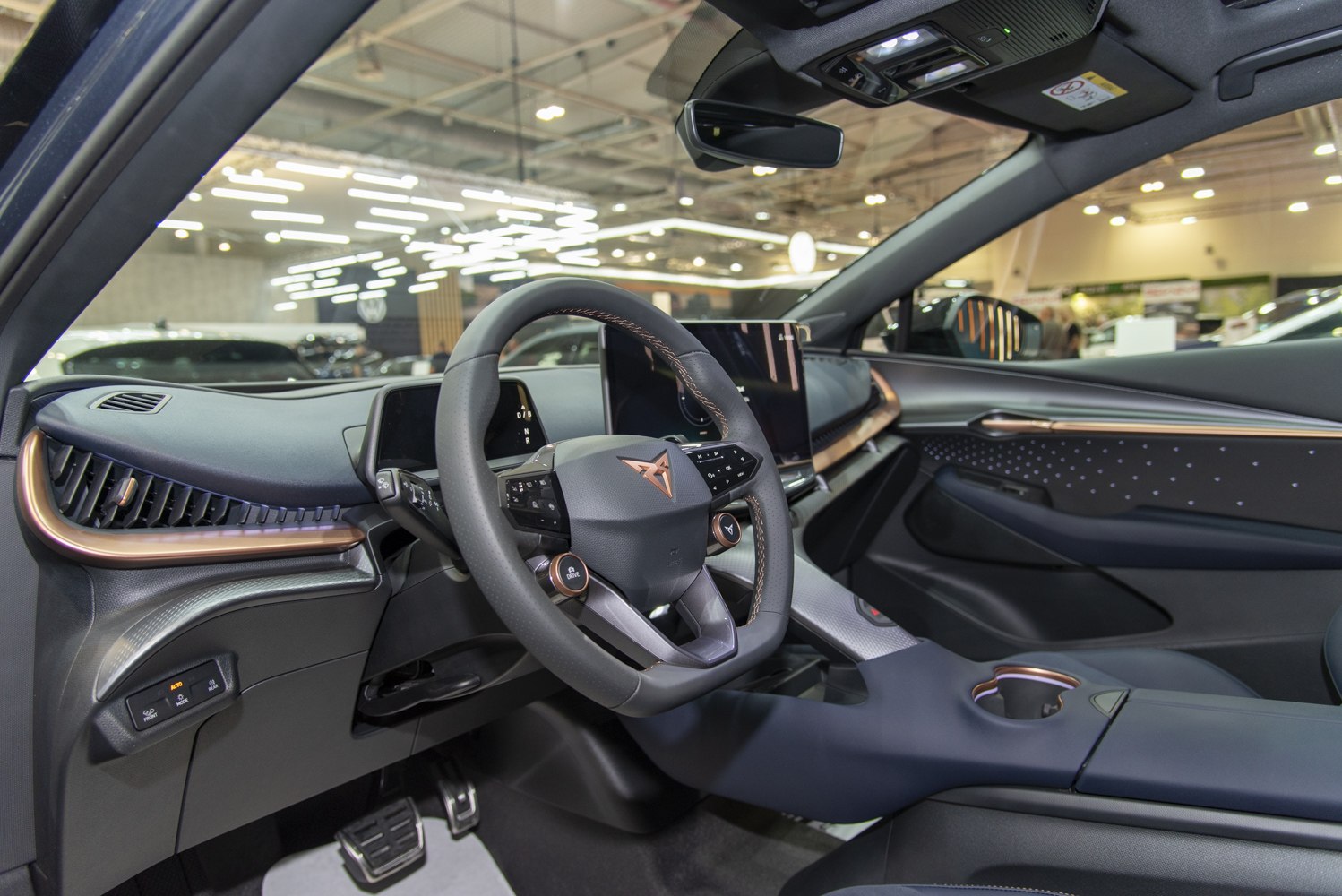 Electric SUV interior with digital dashboard and multifunction steering wheel.
