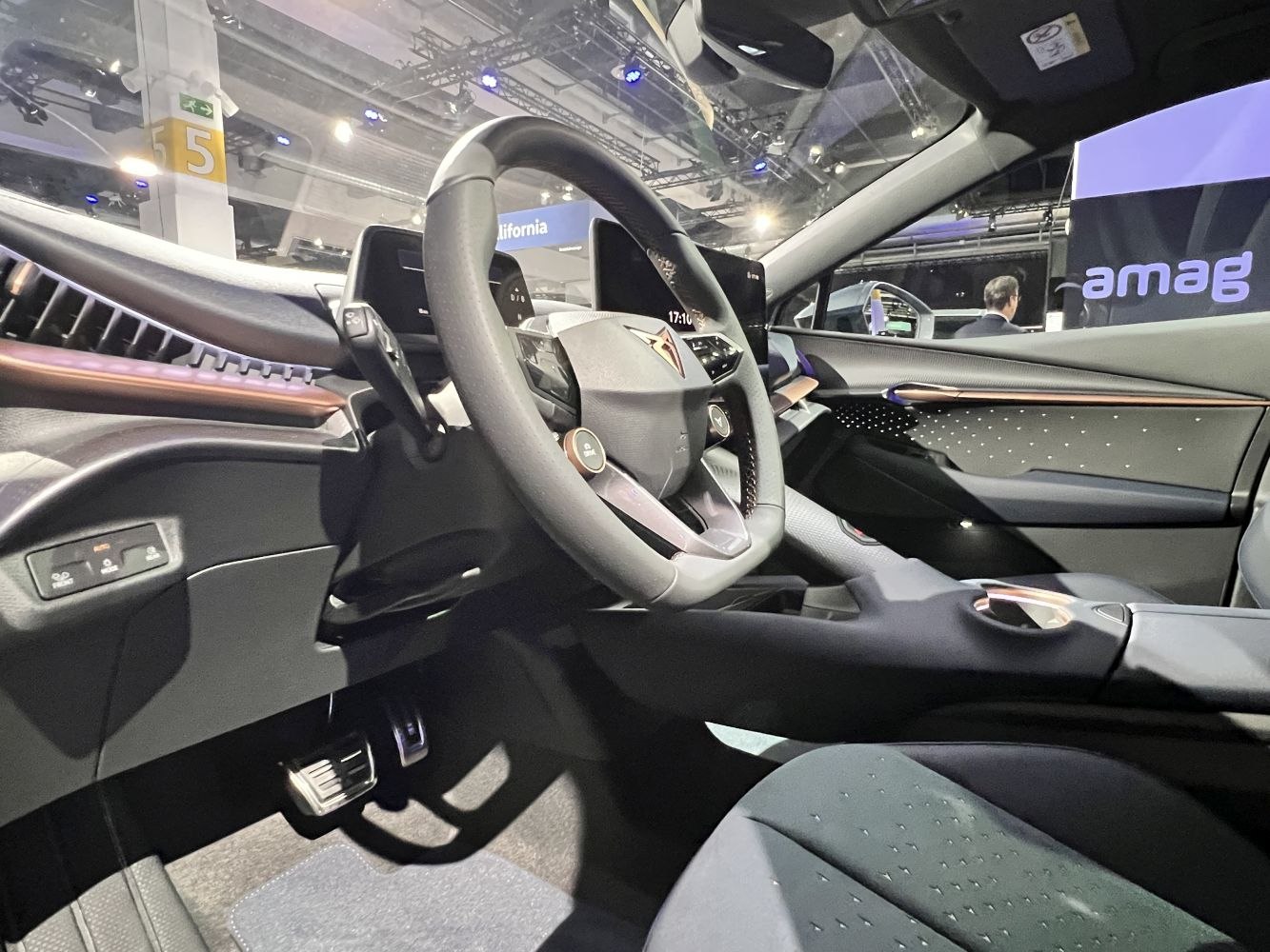 Modern steering wheel and digital dashboards inside a vehicle interior.