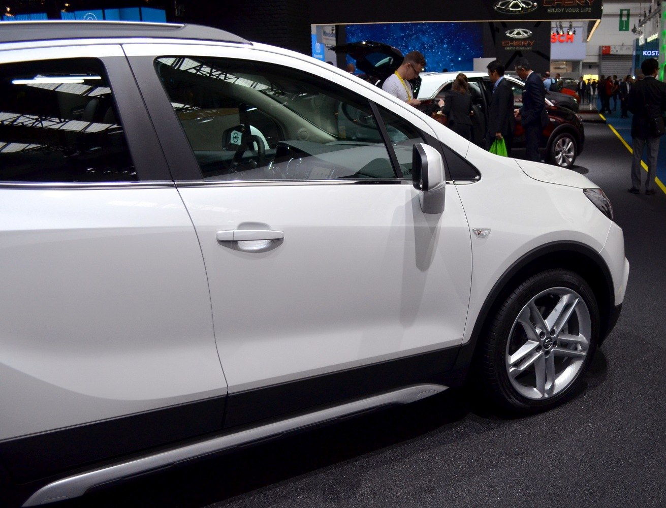 Side profile showing door, side mirror, and alloy wheel.