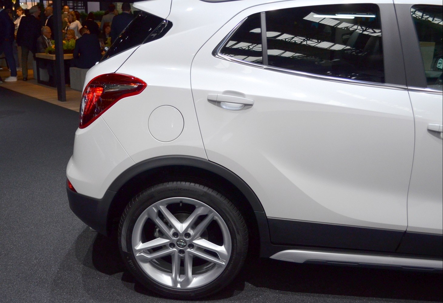 Rear side of white compact SUV with alloy wheel and tail light