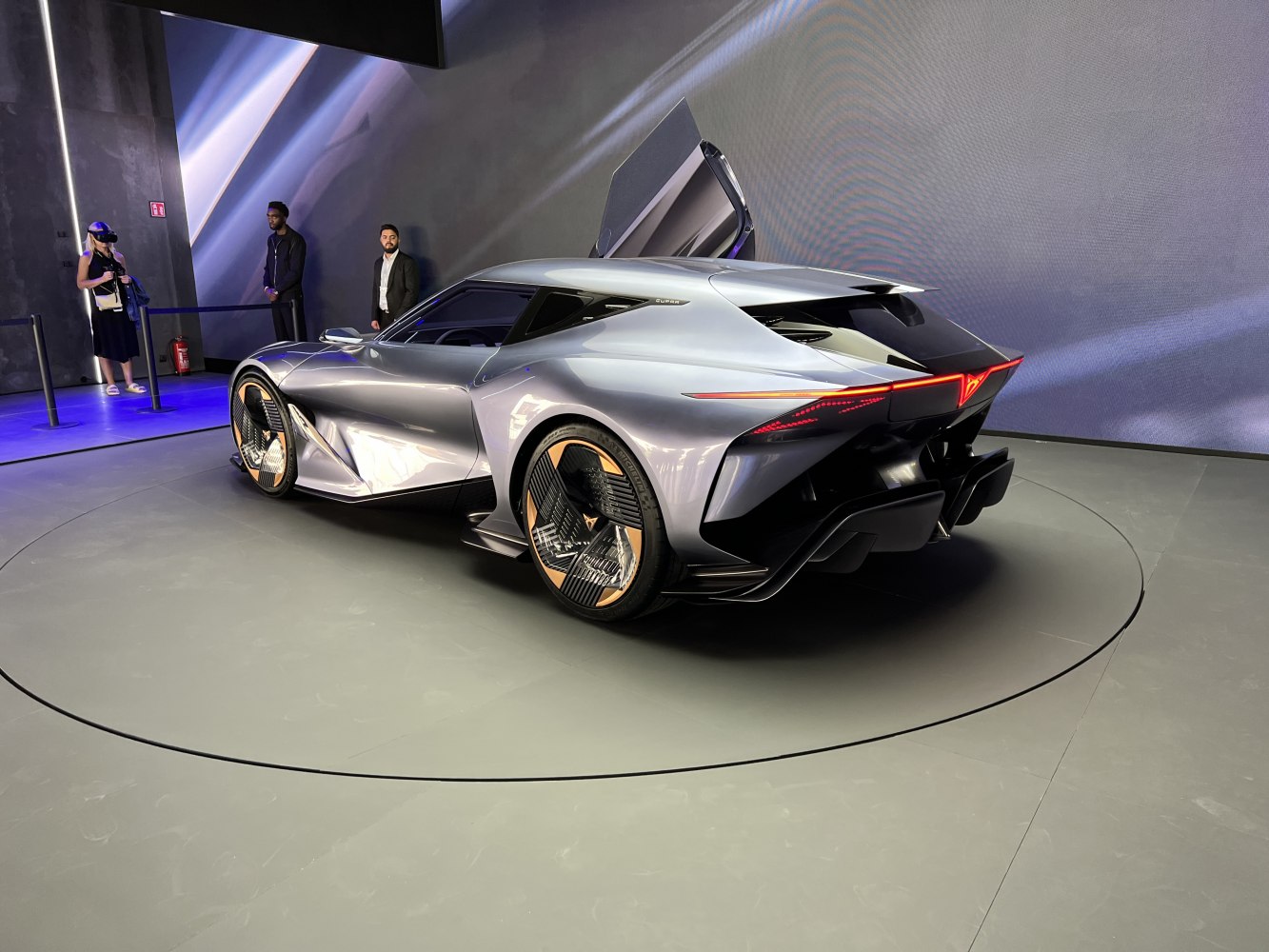 Aerodynamic electric coupe with scissor doors and sleek rear light strip