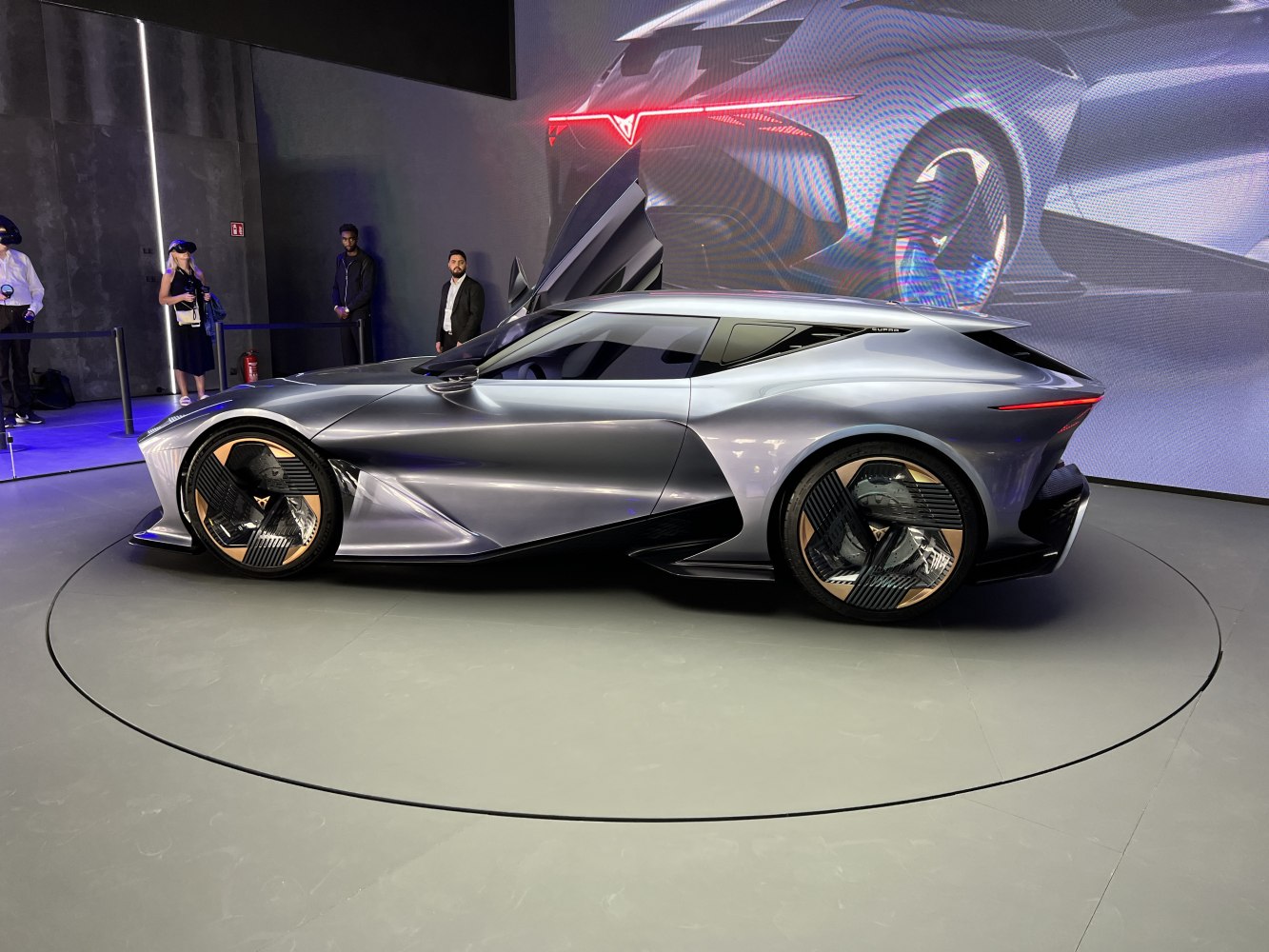 Sleek aerodynamic body and geometric styled wheels side view.