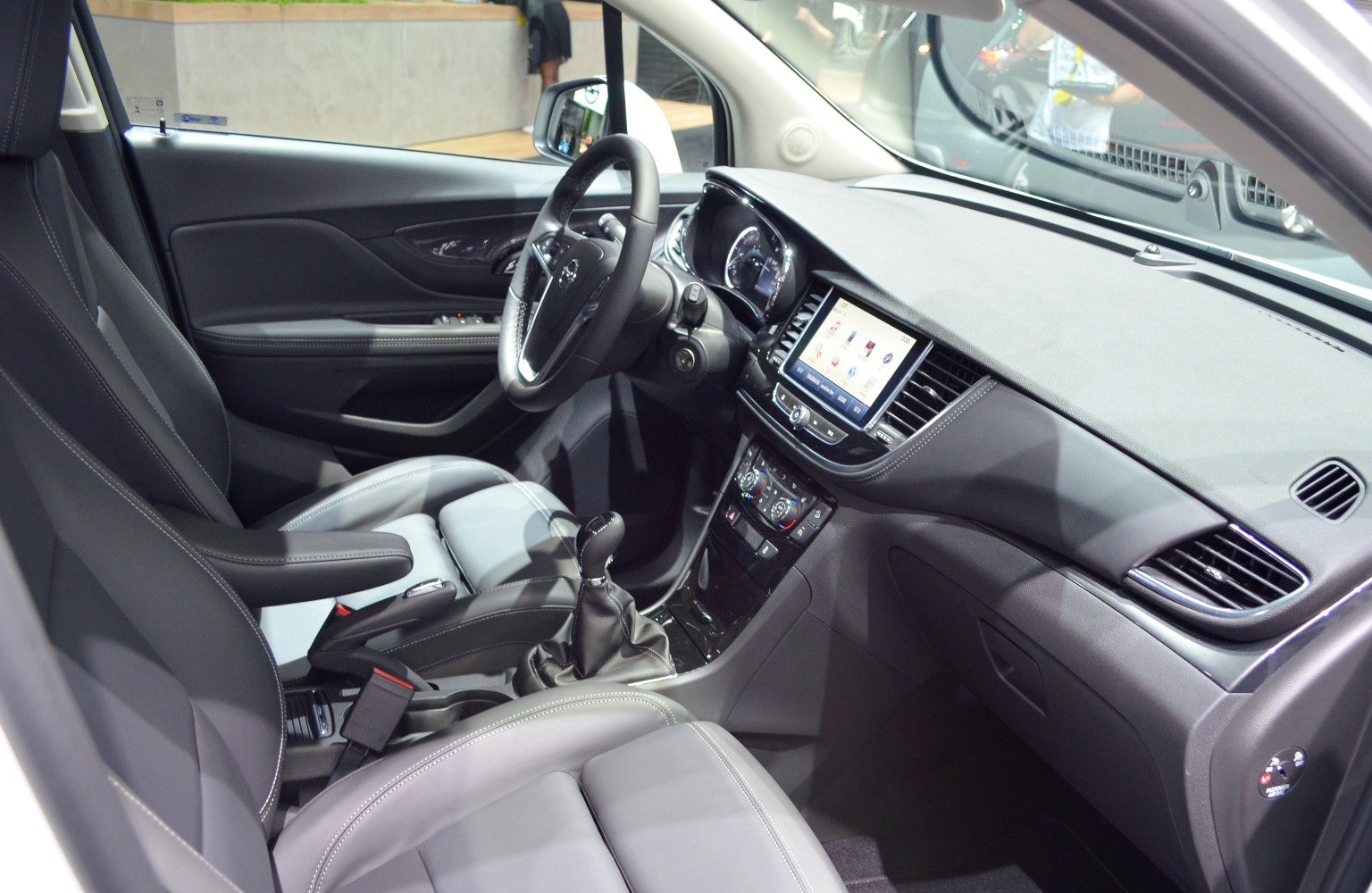 Dashboard layout with touchscreen and leather seating in 2017 SUV interior