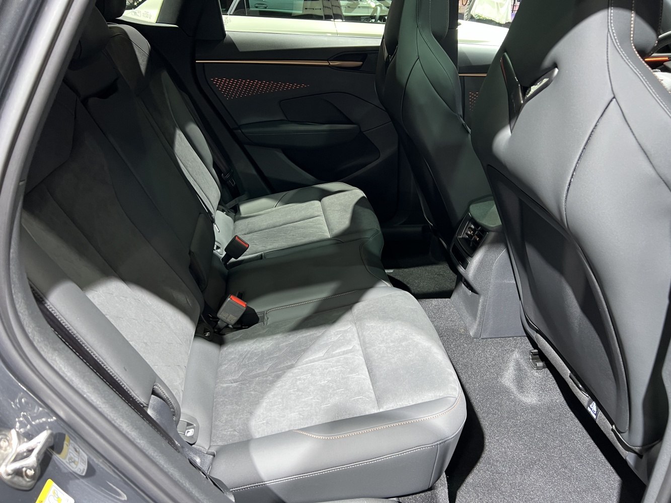 Rear seating and illuminated door panel with premium upholstery.