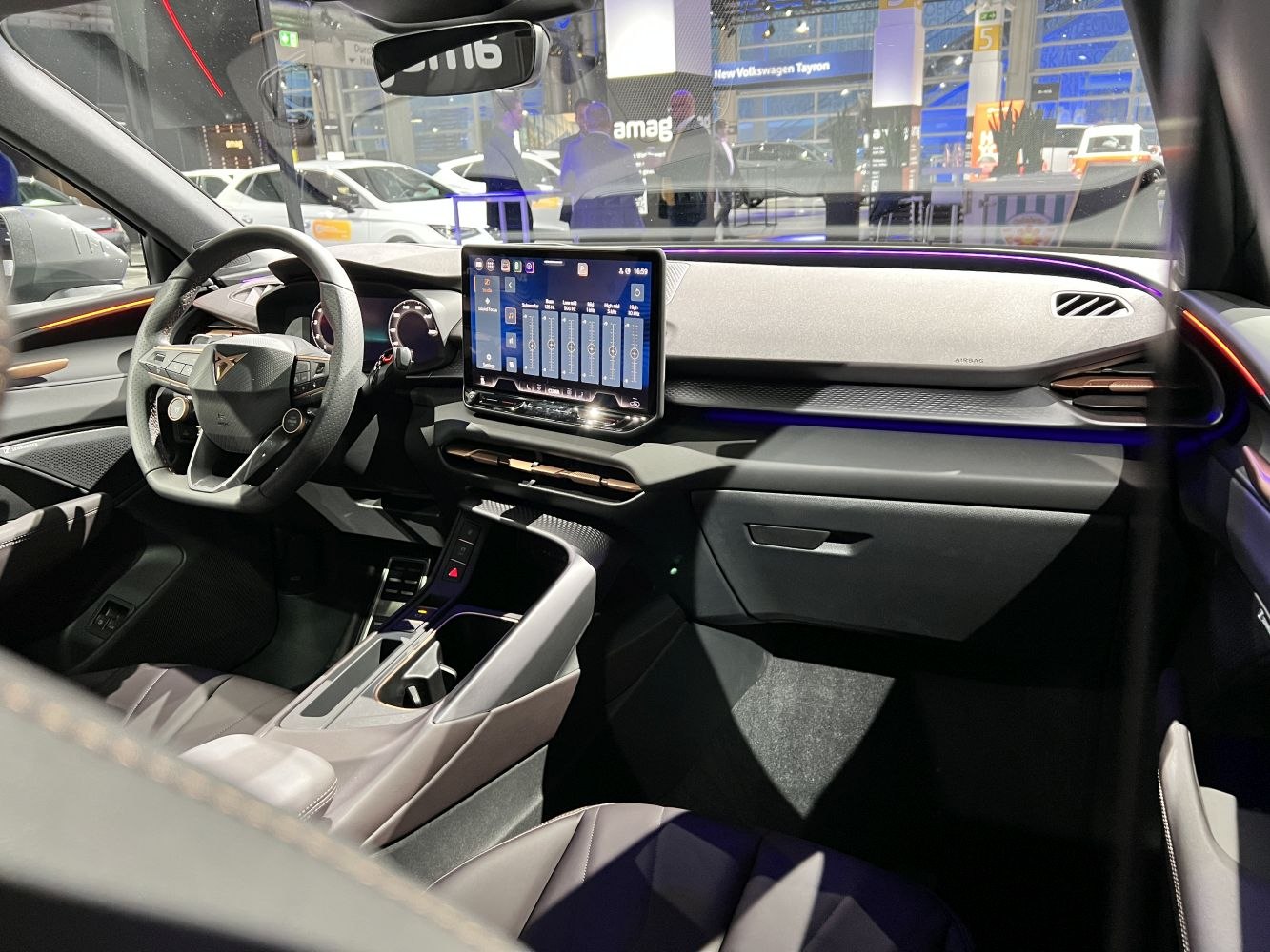 Digital dashboard, touchscreen infotainment, and ambient lighting inside modern car interior