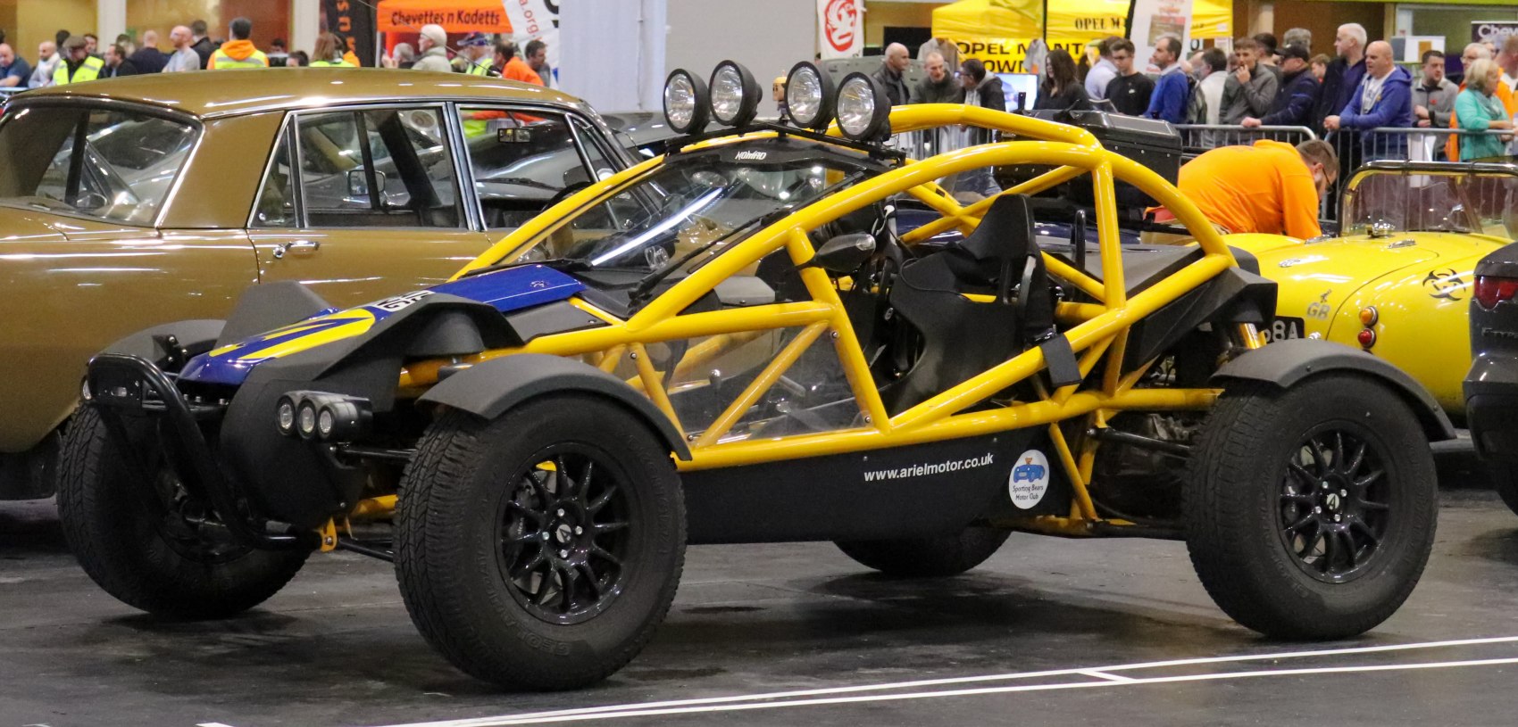 Exposed yellow tubular frame off-road buggy with rally lights